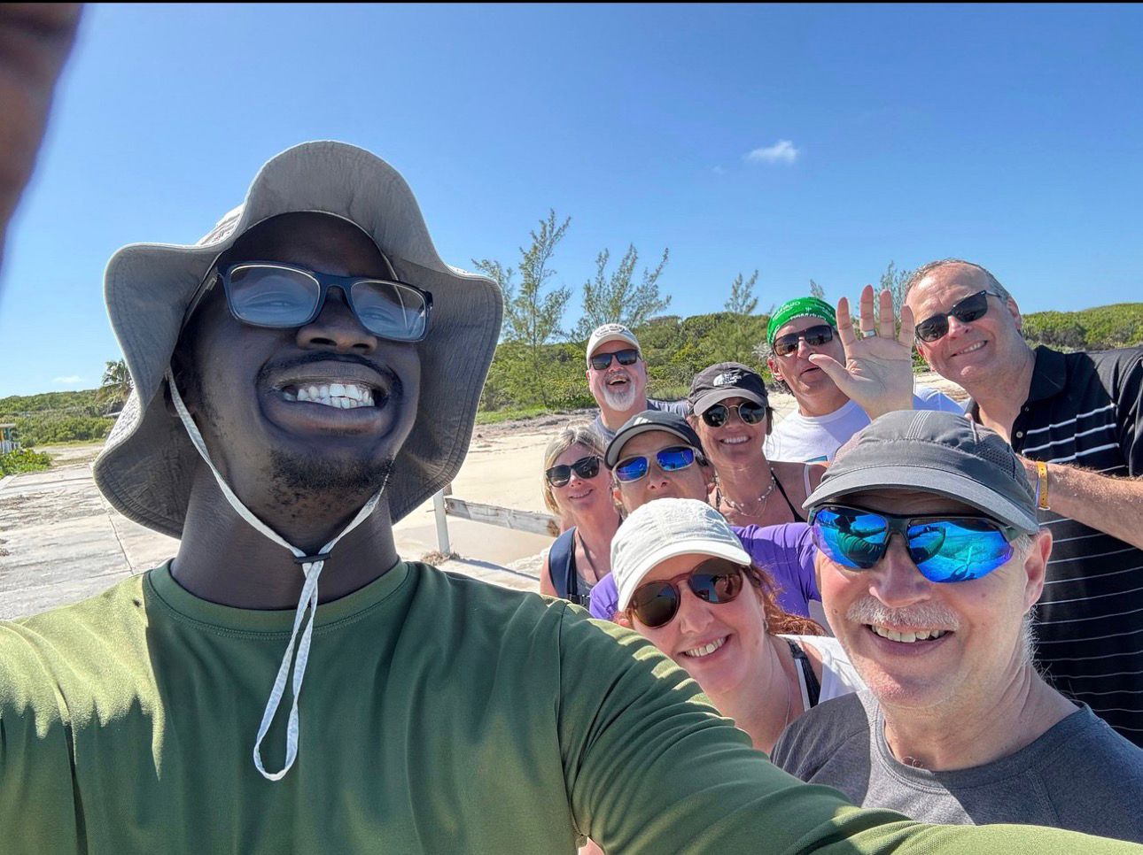 A smiling SunSeekers tour group gathered after an island outing